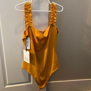 Brand new Aritzia bodysuit. Size small. Never worn, with tags.